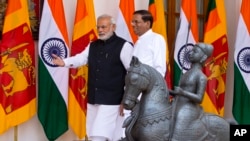 Sri Lanka’s President Maithripala Sirisena, right, and Indian Prime Minister Narendra Modi walk towards a meeting room in New Delhi, India, Monday, Feb. 16, 2015.