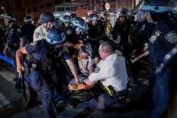 A protester is arrested on Fifth Avenue by NYPD officers during a march, June 4, 2020, in the Manhattan borough of New York.
