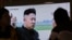 FILE - People watch a TV news program showing a file image of North Korean leader Kim Jong Un, at the Seoul Railway Station in Seoul, South Korea, Feb. 27, 2017. 