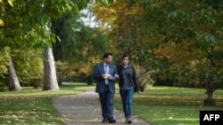 Mirza Dinnayi, left, and Lamia Haji Bashar walk in Stuttgart, Germany, Oct. 28, 2016. Bashar and Nadia Murad, who survived an ordeal at the hands of Islamic State jihadists, won the European Parliament's Sakharov human rights prize, Oct. 27, 2016.