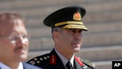 Turkey's Land Forces commander Gen. Salih Zeki Colak follows Prime Minister Binali Yildirim before a meeting of High Military Council with army commanders and ministers, in Ankara, Aug. 2, 2017.