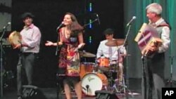 Tambourine player Sean Aucutt (left) and his band, 'Amuma Says No,' performing at The Kennedy Center.