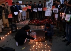 Afghan men light candles for Japanese Dr. Tetsu Nakamura, who was killed in Jalalabad in a terrorist attack, in Kabul, Afghanistan, Dec. 5, 2019.