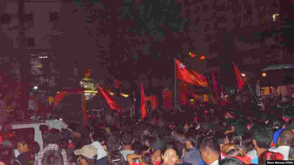 Supporters of the opposition National League for Democracy celebrate outside party headquarters in Yangon, Myanmar, Nov. 9, 2015.