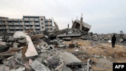 ARCHIVO - Palestinos revisan escombros cerca de una escuela de la ONU que albergaba refugiados después de que un ataque israelí golpeara una casa cercana, en Rafah, en el sur de la Franja de Gaza, el 21 de diciembre de 2023. 