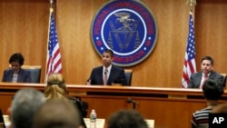 Federal Communications Commission (FCC) Chairman Ajit Pai, center, announces the vote was approved to repeal net neutrality, next to Commissioner Mignon Clyburn, left, who voted no, and Commissioner Michael O'Rielly, who voted yes, at the FCC, Dec. 14, 20