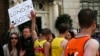 Spectators hold a placard in solidarity with Boston as runners pass them during the London Marathon April 21, 2013.