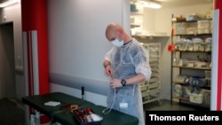 French hospital electrician Benjamin Le Bris repairs a medical bed in the Intensive Care Unit at the hospital in Vannes during the outbreak of the coronavirus disease in France, May 6, 2020.
