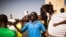 FILE - A man shouts as he and others are seen gathered at the Place de Nation calling for a civilian democratic transition in Ouagadougou, Burkina Faso, Nov. 2, 2014.