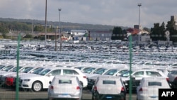 FILE - A picture taken on Sept. 25, 2015 shows cars parked at the logistics park of German auto giant Volkswagen in Villers-Cotterets. 
