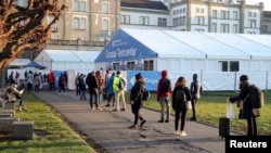 People line up at a COVID-19 testing site of the Stadtspital Waid and Triemli hospital, as the spread of the coronavirus disease continues in Zurich, Switzerland, Dec. 18, 2020.