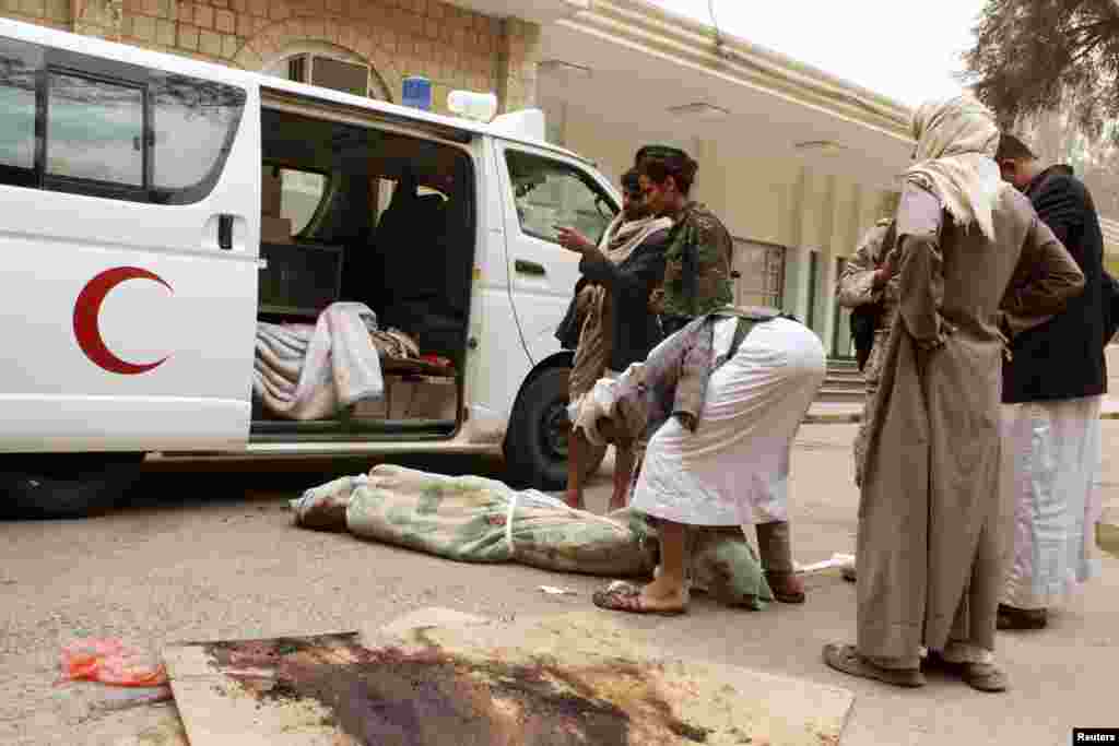 A man wraps the body of a relative killed in an airstrike in Yemen's northwestern province of Saada, March 27, 2015.