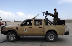 FILE - Afghan army soldiers patrol after the American military left Bagram air base, in Parwan province north of Kabul, Afghanistan, July 5, 2021.