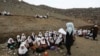 FILE - Afghan students attend school classes in an open-air primary school on the outskirts of Kabul, Afghanistan, April 5, 2017. 