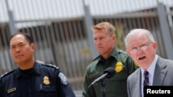 U.S. Attorney General Jeff Sessions holds a news conference next to the U.S. Mexico border wall to discuss immigration enforcement actions of the Trump Administration near San Diego, California, May 7, 2018. 