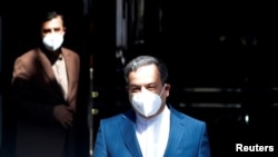 Iranian Deputy at Ministry of Foreign Affairs Abbas Araghchi and Iran's ambassador to the U.N. nuclear watchdog Kazem Gharibabadi leave a meeting of the JCPOA Joint Commission, in Vienna, Austria, April 9, 2021
