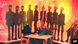 "Signing the unity accord:" In 1987, after years of violence against supporters, Joshua Nkomo (Zimbabwe African People�s Union, ZAPU) signed an accord for a unity government with Mr Mugabe. Maseko depicts this moment with blood pouring onto Nkomo's cowed