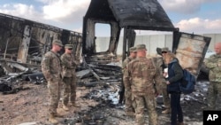 U.S. soldiers stand amid damage at a site of Iranian bombing at Ain al-Asad air base, in Anbar, Iraq, Jan. 13, 2020. 