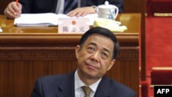 In a file picture taken on March 5, 2012, Chongqing mayor Bo Xilai (bottom C) attends the opening session of the National People's Congress (NPC) at the Great Hall of the People in Beijing.