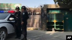 Police officers on duty in the vicinity of a center believed to be used for re-education in Korla in western China's Xinjiang region, Nov. 2, 2017.