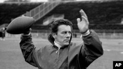 FILE - Len Dawson of the Kansas City Chiefs running through passing drills with receivers in New Orleans to prepare for the Super Bowl, in January 1970.