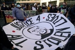 Demonstrators gather outside the Hennepin County Government Center, in Minneapolis, Minnesota, March 8, 2021, ahead of the trial of former police officer Derek Chauvin, accused in the death of George Floyd.