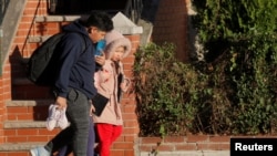 Students exit a school following an announcement closing New York City public schools, as the coronavirus pandemic continues to spread, in Brooklyn, New York, Nov. 18, 2020.