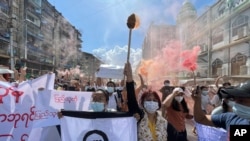 Protesters march holding slogans during a protest at Pazundaung township in Yangon, Myanmar, Wednesday July 14, 2021. (AP Photo)