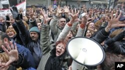 July 23: A woman holds her child at a ocal hospital where children receive treatment for malnutrition at the border town of Dadaab, Kenya. The drought in the Horn of Africa and the famine in Somalia has left more than two million children at risk of star