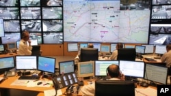 FILE - Police officers work at Paris Prefecture control room, in Paris, Nov. 10, 2016. 
