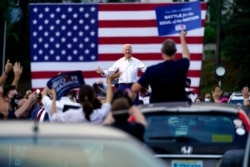 Democratic presidential candidate former Vice President Joe Biden greets supporters at a drive-in rally at Cellairis Amphitheatre in Atlanta, Oct. 27, 2020.
