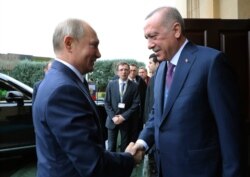 FILE - Turkish President Recep Tayyip Erdogan, right, welcomes Russian President Vladimir Putin, in Istanbul, Jan. 8, 2020.
