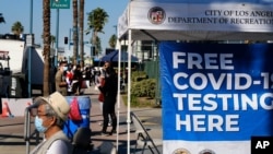 People wait in line to be tested for COVID-19 at a testing site in the North Hollywood section of Los Angeles on Dec. 5, 2020.