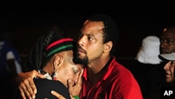 Vizion Jones, center, holds Mercedes Binns, left, after hearing the news of the execution of Georgia death row inmate Troy Davis in Jackson, Ga., Davis was executed Wednesday for killing off-duty Savannah officer Mark MacPhail, September 21, 2011.