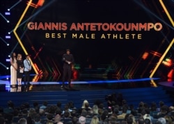 NBA player Giannis Antetokounmpo of the Milwaukee Bucks, accepts the award for best male athlete at the ESPY Awards, July 10, 2019, at the Microsoft Theater in Los Angeles.