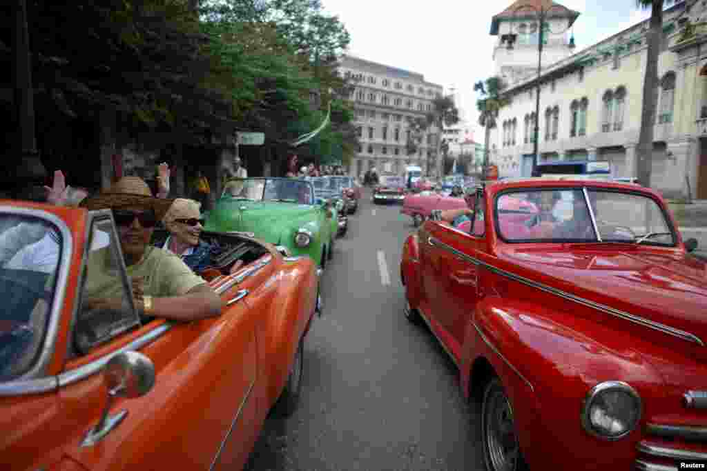 Tourists enjoy a ride in vintage cars in old Havana, Cuba, Jan. 17, 2016. 