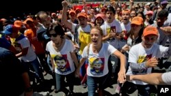 FILE - Lilian Tintori, center right, wife of jailed opposition leader Leopoldo Lopez and Lopez's mother Antonieta Mendoza, center left, shout "Freedom for Leopoldo" during a rally in Caracas, Venezuela, Feb. 18, 2017.