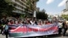 FILE - Members of Kenya's ruling Jubilee coalition carry a banner as they demonstrate in support of the Independent Electoral and Boundaries Commission (IEBC) the electoral body ahead of next year's election in Nairobi, Kenya, June 8, 2016. 