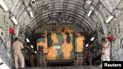 Turkish troops are shown unloading a vehicle at their military base in Doha, Qatar, June 23, 2017. 
