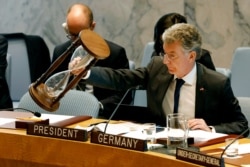 FILE - Germany's Ambassador Christoph Heusgen resets an hour glass between speakers at United Nations headquarters, April 29, 2019.
