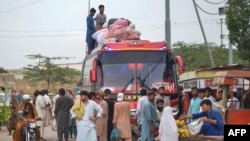 FILE - Afghan refugees board a bus from Karachi, Pakistan, to Afghanistan on Sept. 21, 2023. Afghans have poured into Pakistan by the millions during decades of successive wars. Pakistani officials on Oct. 3, 2023, ordered undocumented immigrants to leave the country by Nov. 1.