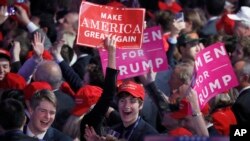 FILE - Supporters cheer as they wait for President-elect Donald Trump to give his acceptance speech during his election night rally, in New York, Nov. 9, 2016.