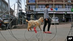 A Kashmiri Muslim civilian crosses a check point ahead of Eid -ul Adha during curfew in Srinagar, Indian-controlled Kashmiri, Aug. 9, 2019.