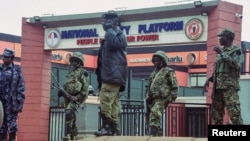 Uganda security forces stand guard outside the National Unity Platform political party offices led by Robert Kyagulanyi, popularly known as Bobi Wine, ahead of anti-government protests at the Makerere Kavule, in the suburb of Kampala, Uganda, July 22, 2024. 