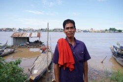 Nan Sok, a 60-year-old Khmer Islam fisherman, stands in front of Tonle Sap behind his house on the outskirts of Phnom Penh, Cambodia.(Malis Tum/VOA Khmer)