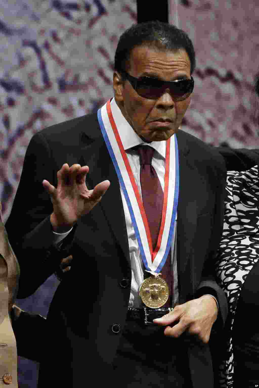 Retired boxing champion Muhammad Ali waves after he received the Liberty Medal for his humanitarian work, during a ceremony at the National Constitution Center, Thursday, Sept. 13, 2012, in Philadelphia. (AP Photo/Matt Rourke)