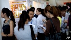 FILE - Chinese job seekers visit a job fair held at the China International Exhibition Center in Beijing. 