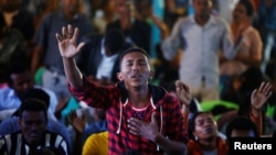 A man attends a prayer session at Biftu Bole Lutheran Church during a prayer and candle ceremony for protesters who died in the town of Bishoftu two weeks ago during Irreecha, the thanksgiving festival of the Oromo people, in Addis Ababa, Ethiopia, October 16, 2016. 