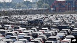 FILE - In this Wednesday, June 3, 2020 filer photo, new cars are stored at the 'logport' (logistic port) in Duisburg, Germany where the industrial production plunged by nearly 18%. 