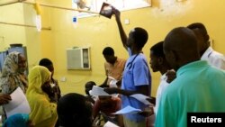 FILE - A doctor looks at an X-ray of a victim of violence in the crackdown on Sudanese protesters, inside a ward in a hospital in Omdurman, Khartoum, Sudan, June 10, 2019.